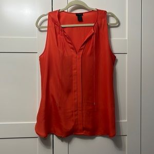 Orangey-red sleeveless blouse